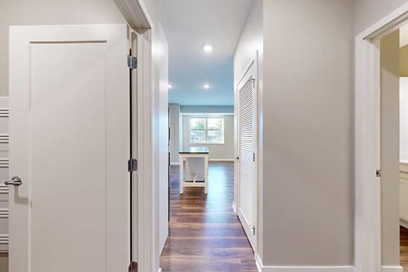 A hallway leading from the front entryway to the open kitchen and living area.