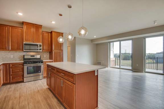A kitchen with wooden cabinets and a white countertop.