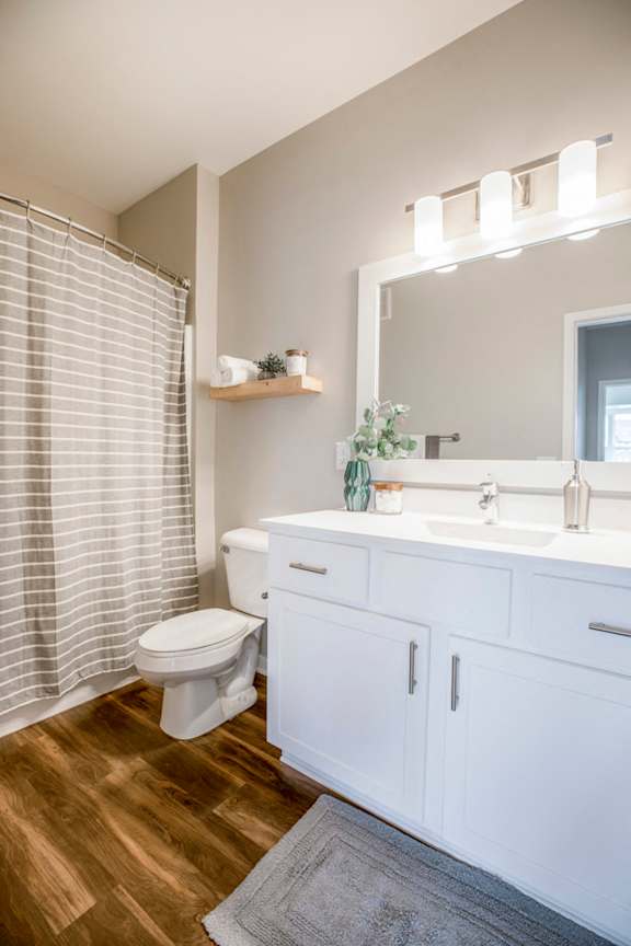 Bathroom with white cabinetry at Ascend at Woodbury new luxury apartments in Woodbury MN 55129