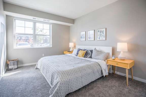 Bedroom with large windows at Ascend at Woodbury new luxury apartments in Woodbury MN 55129