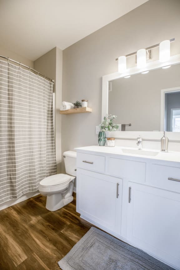 Bathroom with white cabinetry at Ascend at Woodbury new luxury apartments in Woodbury MN 55129