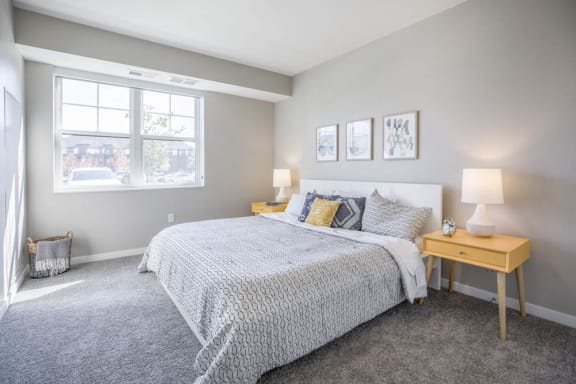 Bedroom with large windows at Ascend at Woodbury new luxury apartments in Woodbury MN 55129