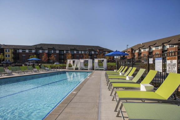 Outdoor swimming pool with cabanas and lounge chairs at Ascend at Woodbury MN 55129 new luxury apartments