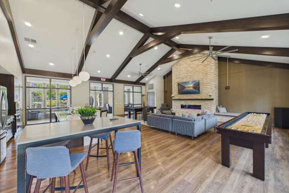 A modern open plan living and dining area with a pool table.