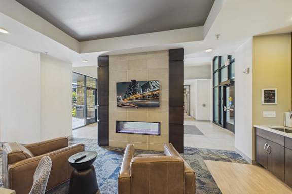 A modern living room with a fireplace and a painting on the wall.