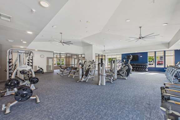 A spacious gym with a variety of equipment.