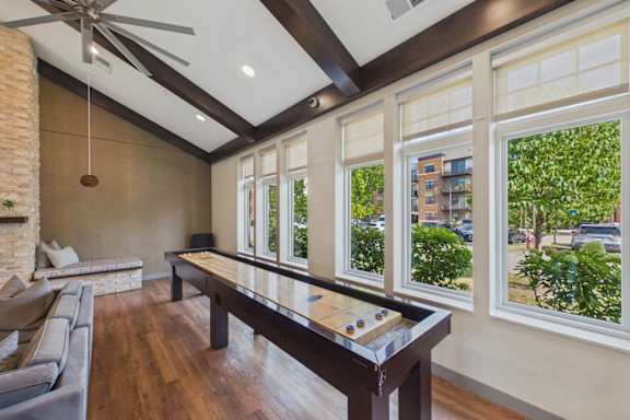 A room with a pool table and a couch.