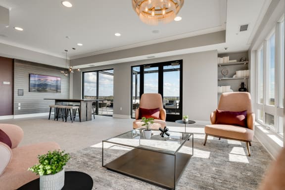Community space with several seating areas and a walk out to an outdoor patio
