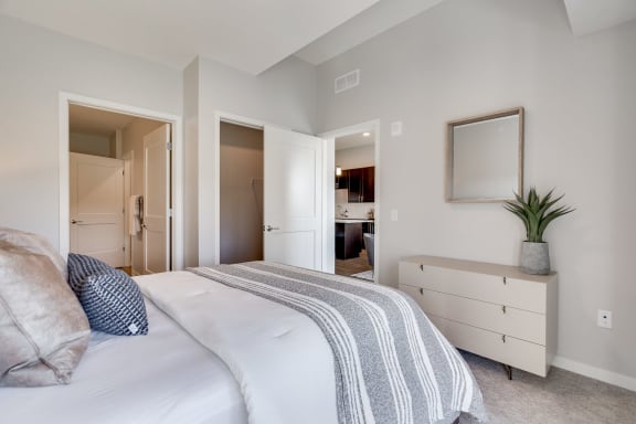 Large bedroom with connected bathroom and walk in closet in luxury apartment In Woodbury MN 55125