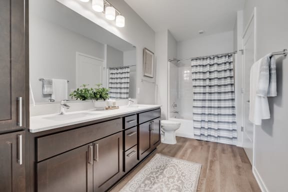 Spacious bathroom with dual vanities and lots of storage in luxury apartment in Woodbury MN 55125