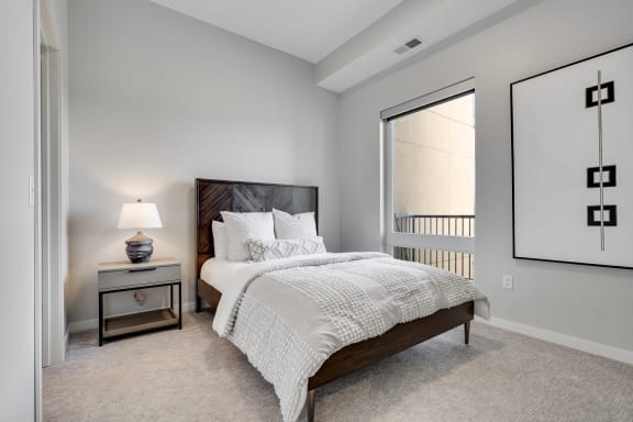 Bedroom with high ceiling and large window in two bedroom luxury apartment Woodbury MN 55125