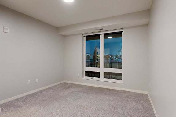 A room with a window overlooking a cityscape.
