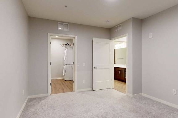 A room with a white door and a white wall.