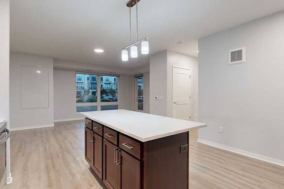 A kitchen with brown cabinets and a white countertop.