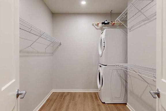 A white laundry room with a washer and dryer.