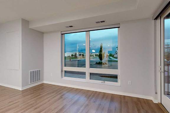 A room with a large window overlooking a cityscape.
