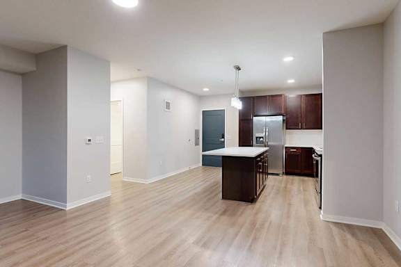 A kitchen area with a counter and cabinets.
