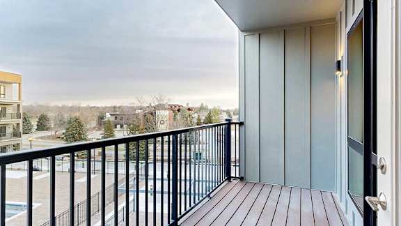 a balcony with a view of the courtyard in the evening