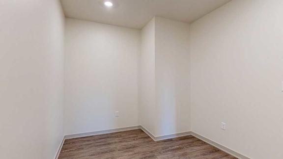A den space with hardwood-style flooring.