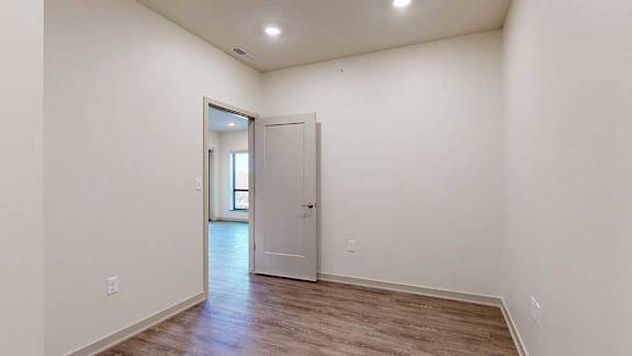 A den space with hardwood-style flooring.