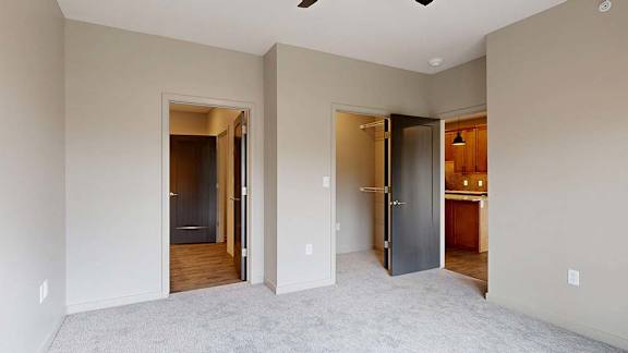 A room with two doors and a carpeted floor.