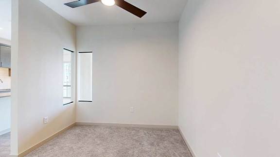 A carpeted sleeping area enclosed with a windowed wall for privacy.