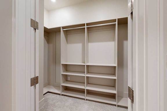 A walk-in closet attached to the primary walk-in closet of the main bedroom.