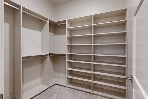 An adjacent walk-in closet off the primary boutique-style closet.