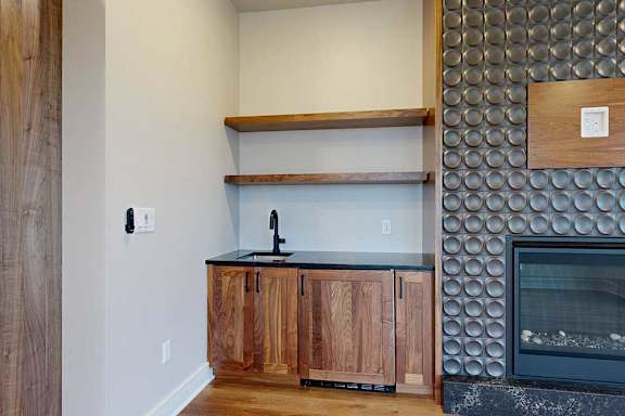 A modern living room with a built-in wet bar.