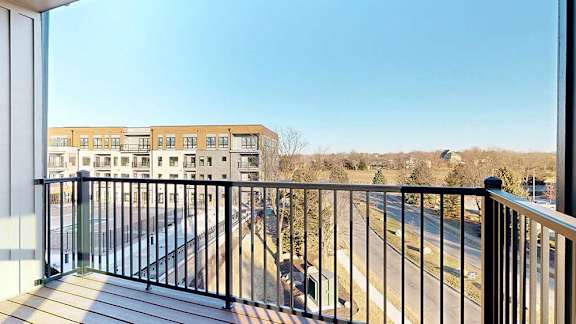 a balcony with a metal railing and a great view of the courtyard