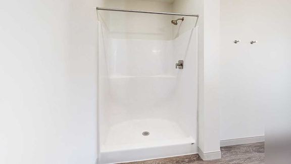a walk-in shower with built-in shelving