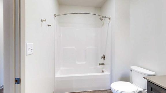 a bathroom with a combination shower and tub