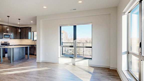 a living room with a large window overlooking the balcony