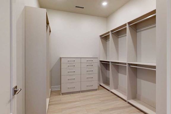 A white closet with drawers and shelves.