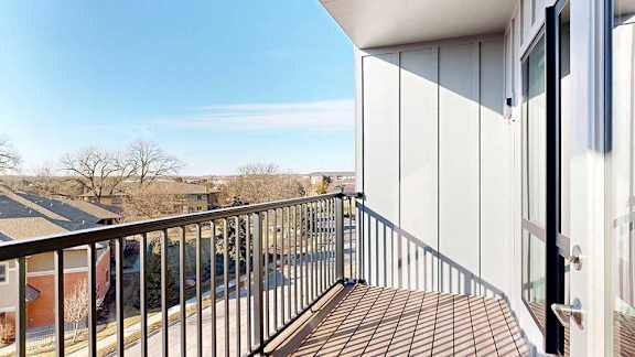 a balcony with a black metal railing and a view of the Villas at Wilderness Ridge across the street