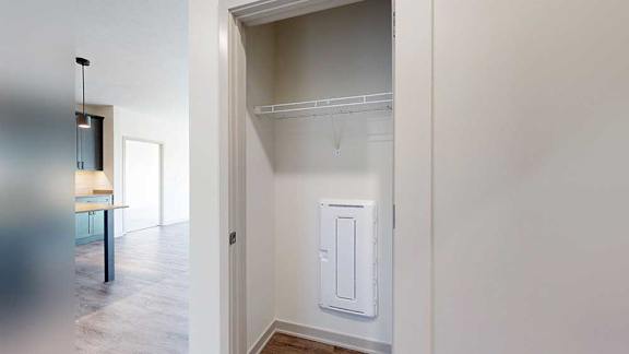 a hallway closet with a built-in shelf