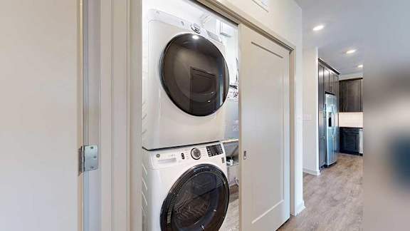 a stackable washer and dryer in a closet