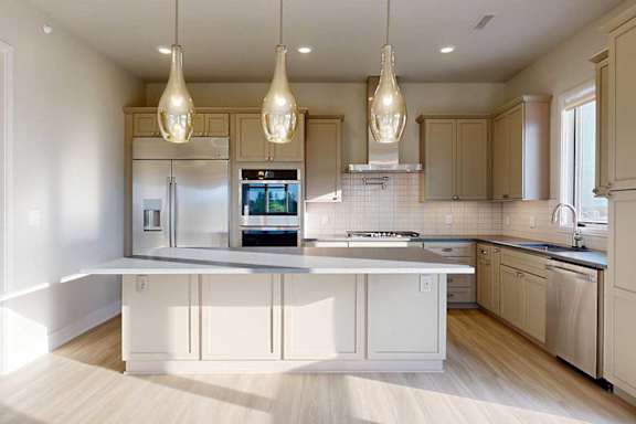 A gourmet kitchen with an oversized island, taupe wooden cabinetry, stainless steel commercial appliances, quartz countertops, a range hood, a tile backsplash, and pendant lighting.