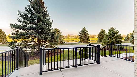 a black metal railing surrounding a walk-out patio