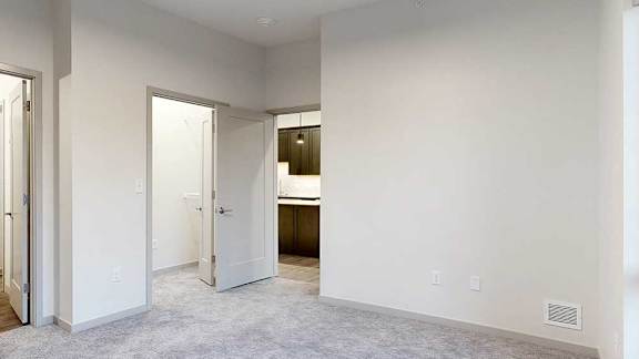 a bedroom with a carpeted floor and white walls