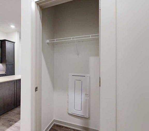 a storage closet with a built-in wire shelf