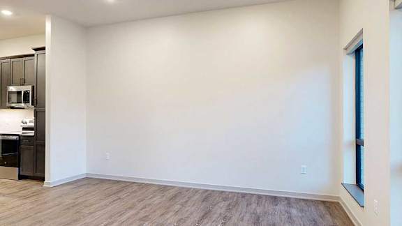 a living room with wooden flooring and white walls