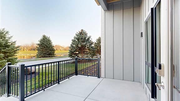 a walk-out patio with a black railing
