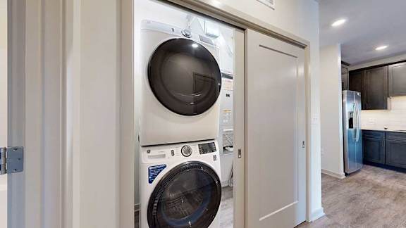 an in-unit stackable washer and dryer in a laundry closet