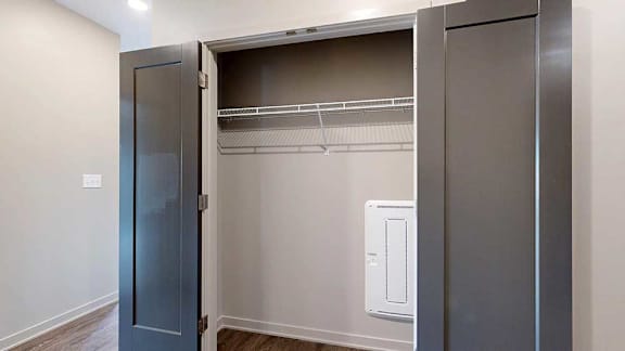 A large, double-door closet with a wire shelf in the front hallway.
