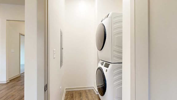 a stackable washer and dryer in a laundry closet