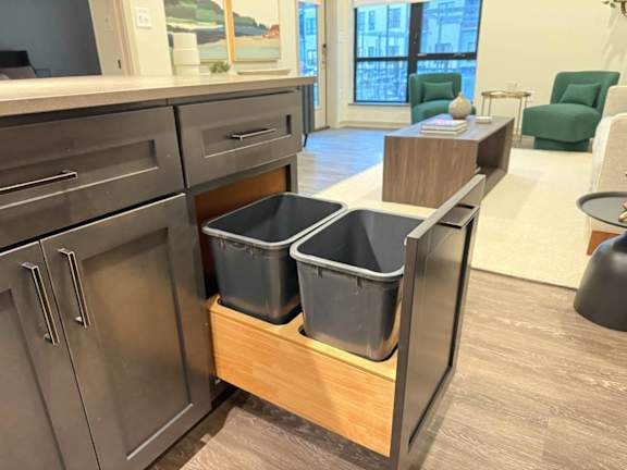 a kitchen with three storage bins in a counter top