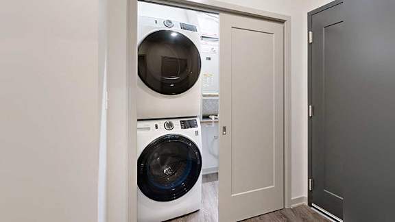 a stackable washer and dryer in a double door closet