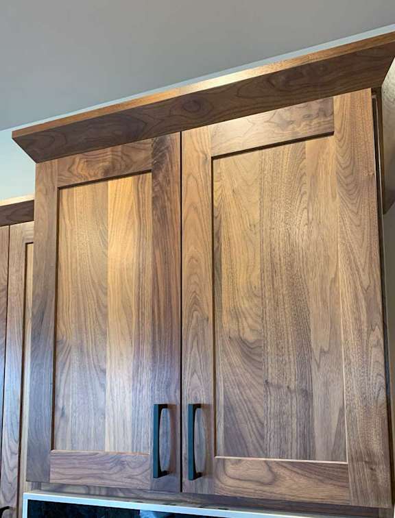 a kitchen with neutral wooden brown cabinetry