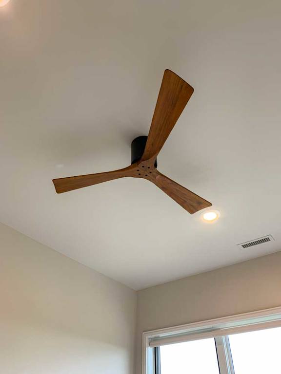 a modern wooden three-blade ceiling fan
